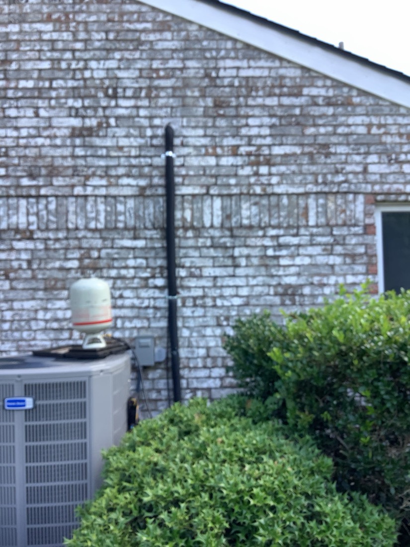 Newly installed HVAC condenser and air handler units with black ductwork.