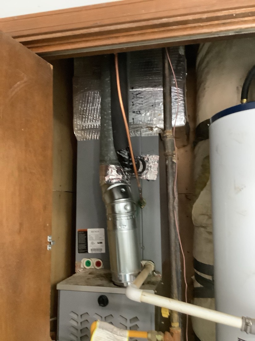 Interior furnace installation with ductwork and copper connections