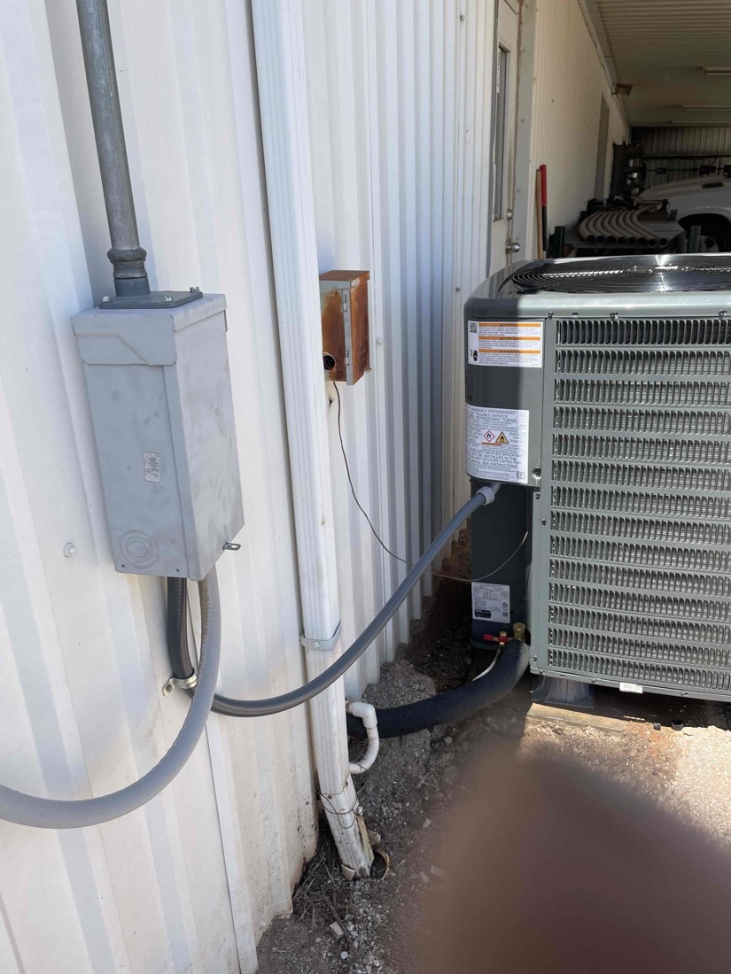 Complete outdoor AC unit installation with ductwork connection