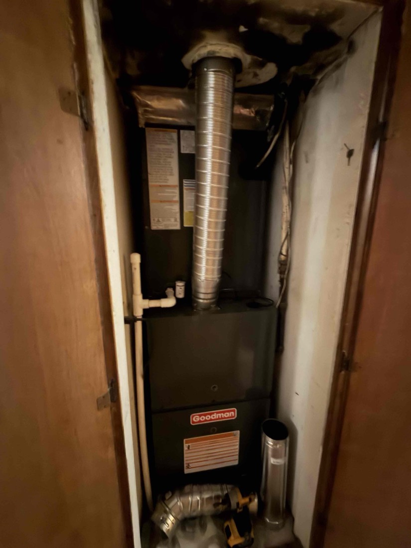 Goodman furnace with silver ductwork installed in utility closet