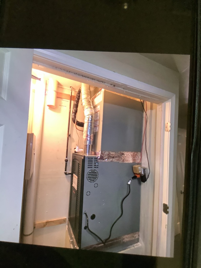 New furnace unit installed in residential closet with ductwork