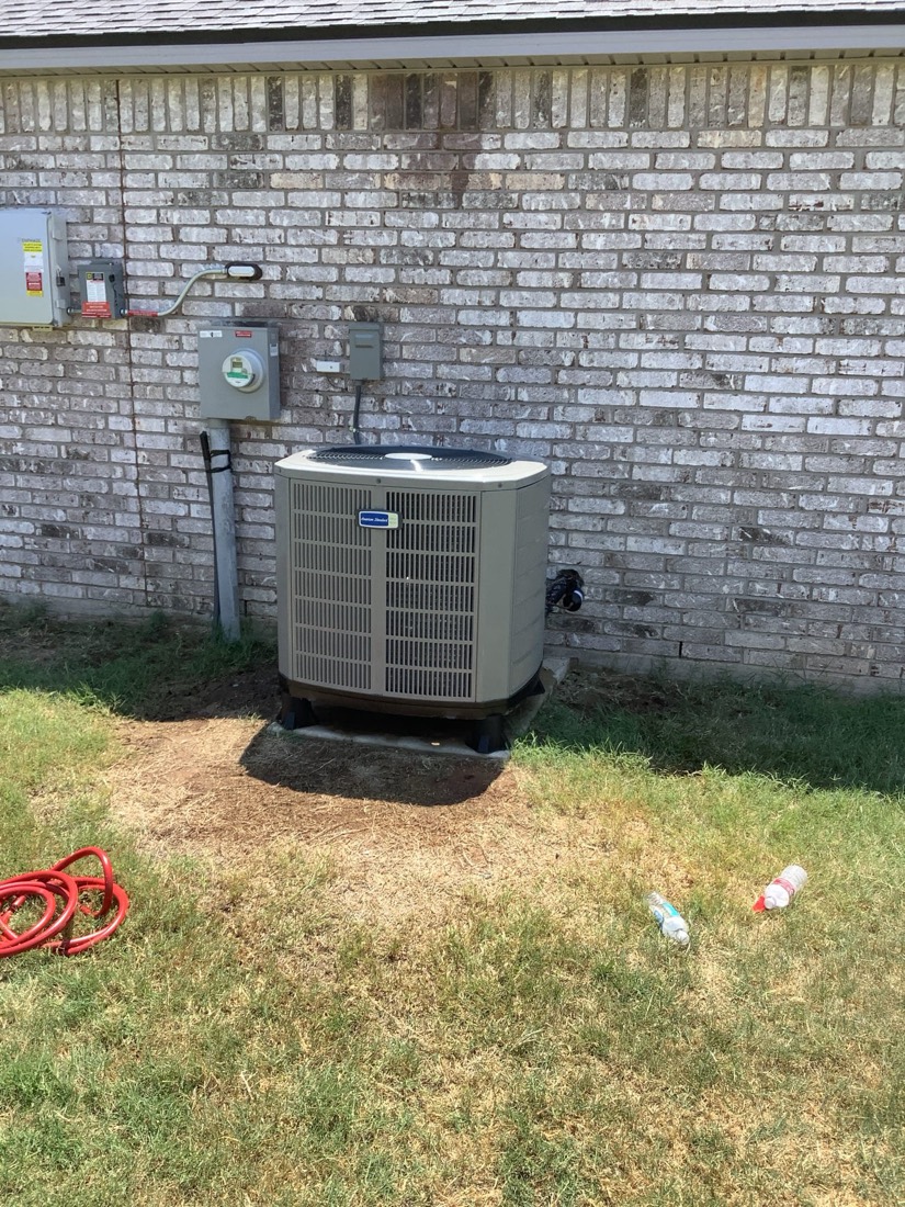 New AC condenser installation in residential yard