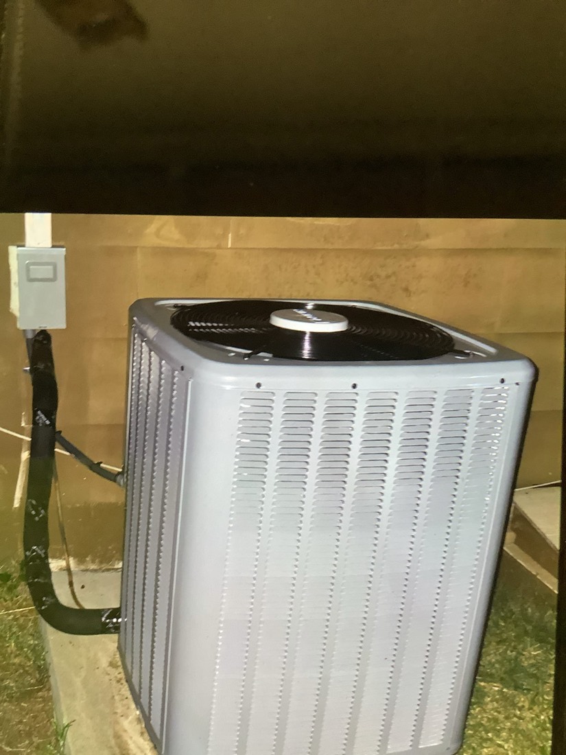 New air conditioning condenser unit installed outside.