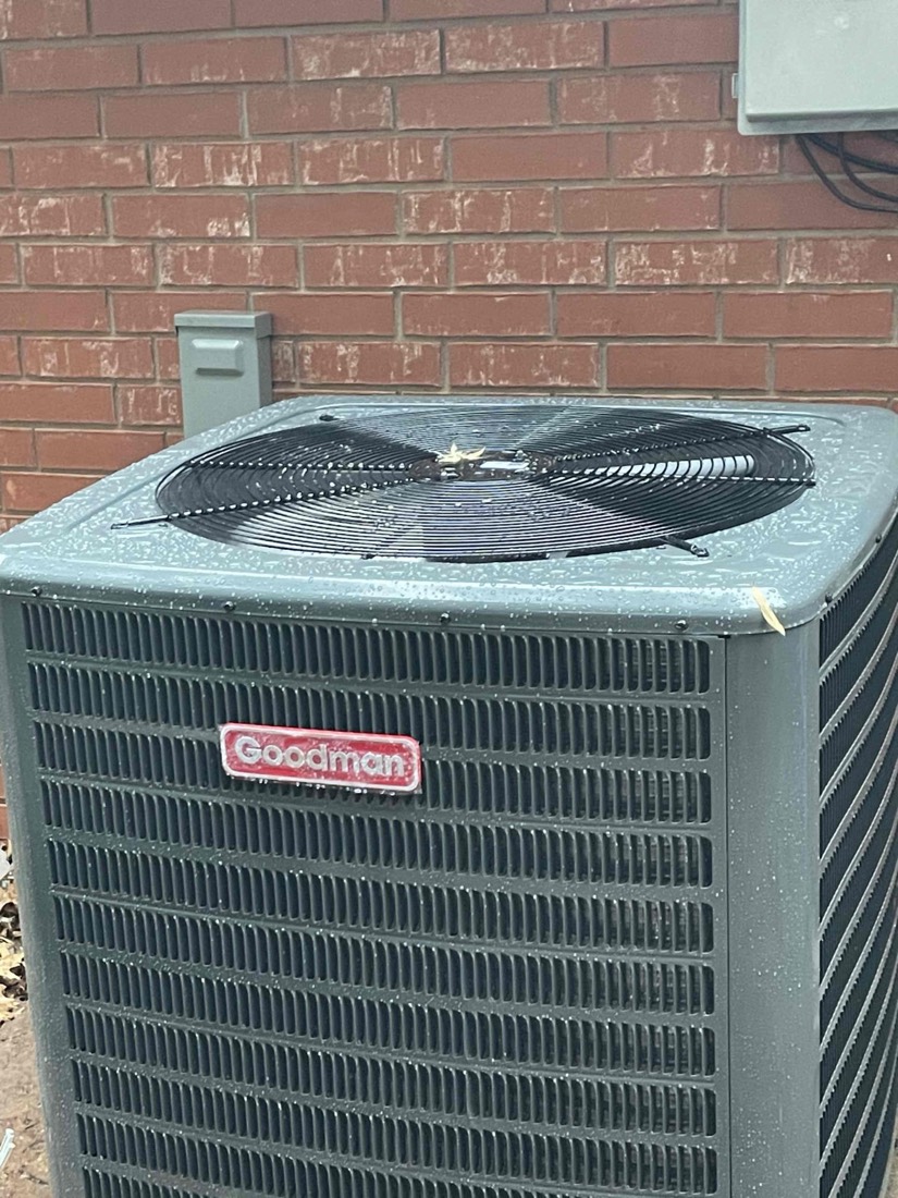 Outdoor AC condenser unit mounted on home exterior.