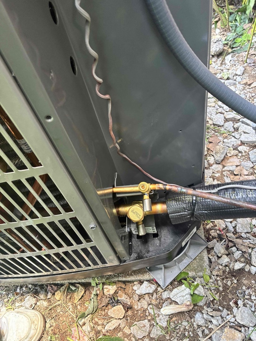 AC condenser unit with refrigerant lines and shut-off valve