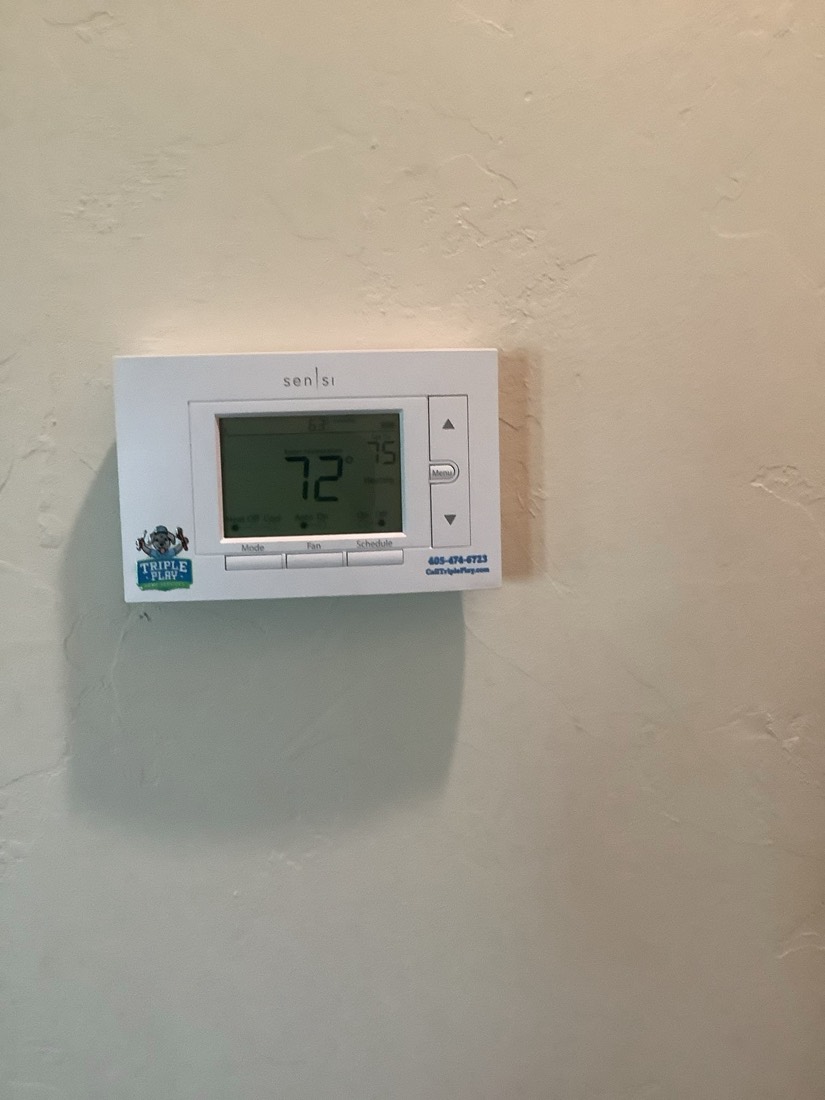 Sensi smart thermostat installed and displaying temperature
