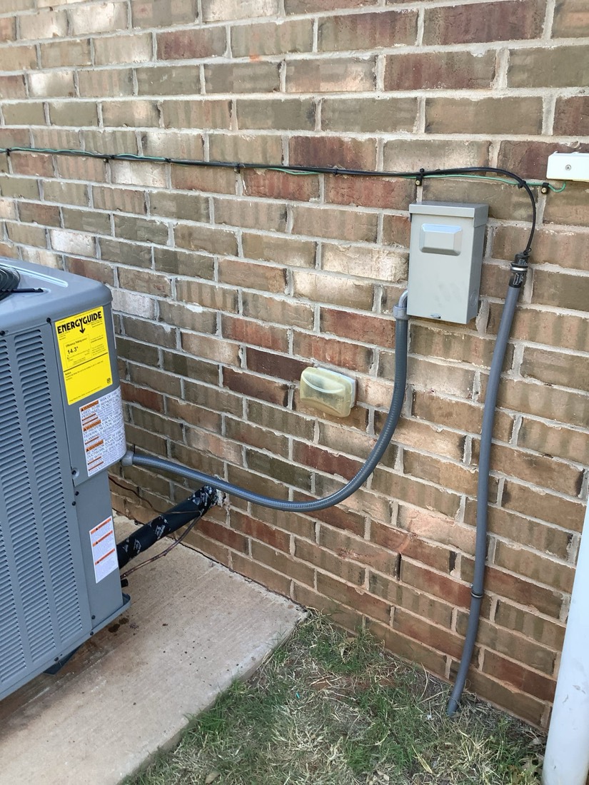 Complete HVAC system with outdoor condenser and connecting lines installed
