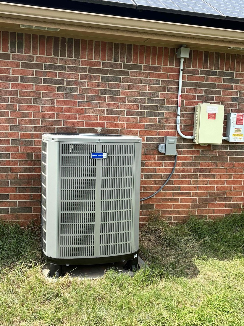 New heat pump with conduit installation on brick wall