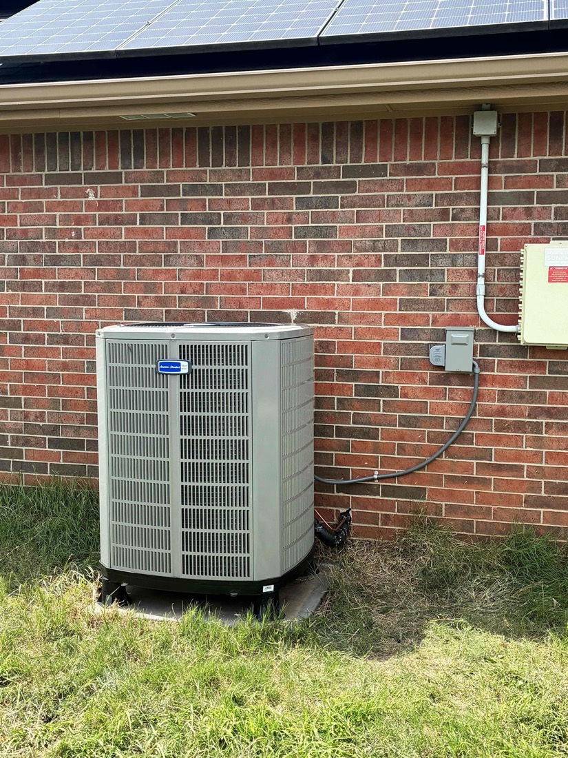 Installed heat pump air conditioning unit on brick home