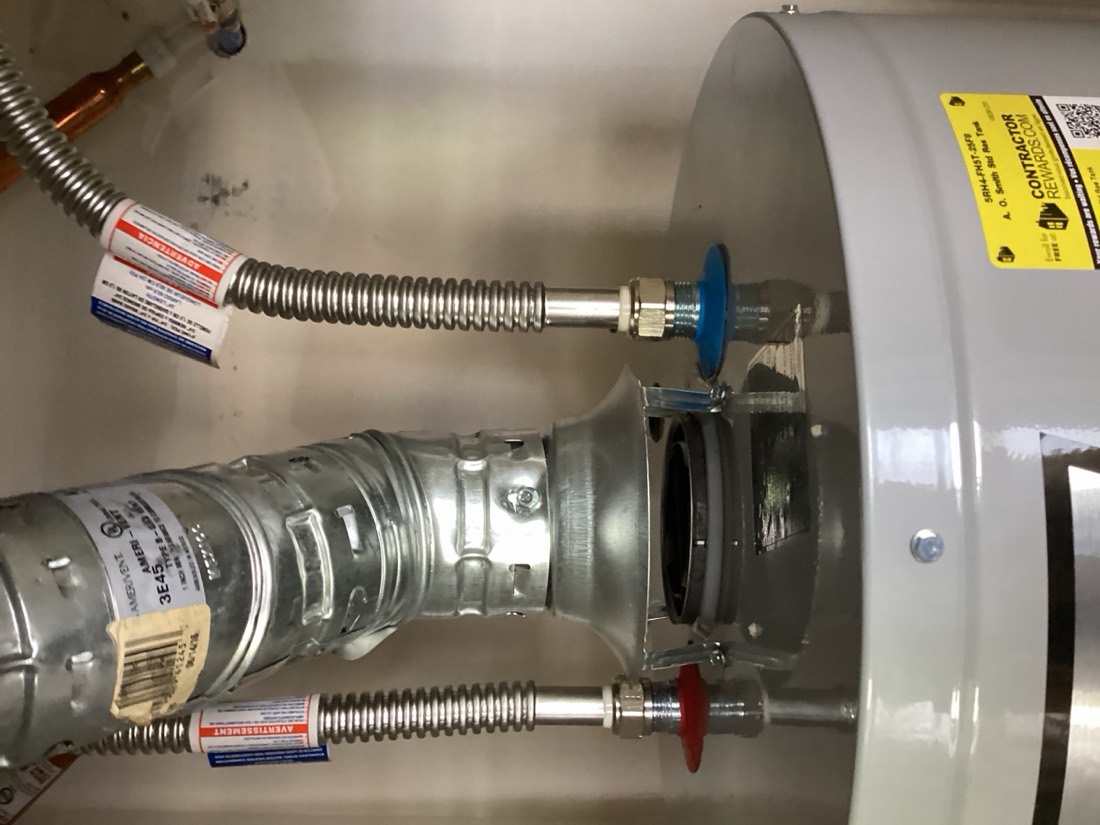 Water heater with relief valve connections and brass fittings.