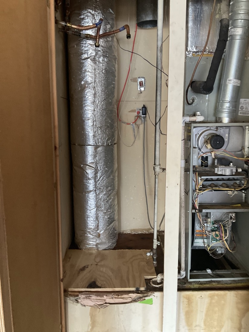 Water heater with insulated tank and plumbing connections during installation