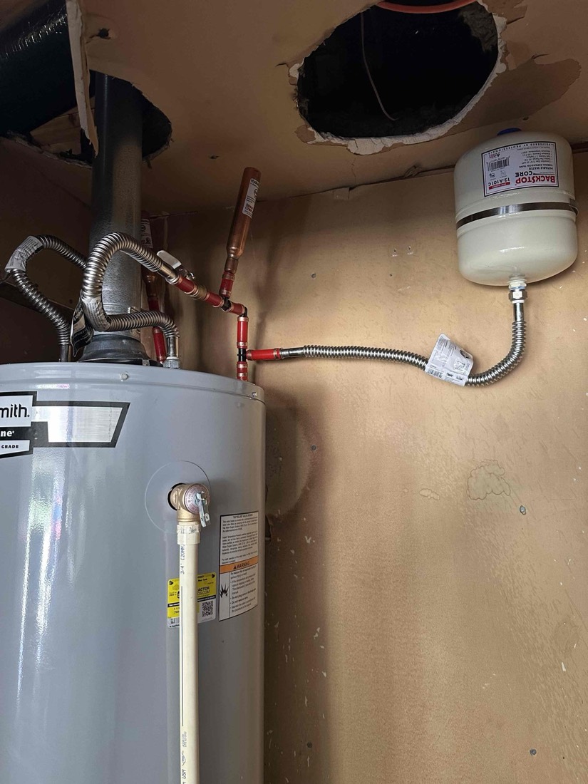 Water heater with expansion tank and properly connected piping