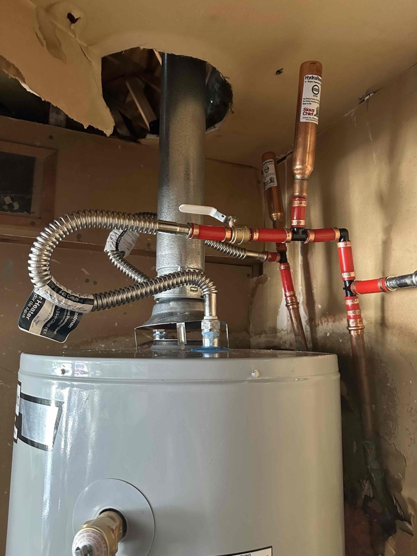 Water heater with red shutoff valves and copper supply lines