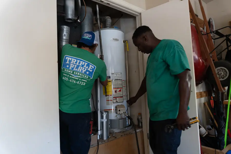 Triple Play workers installing a tank water heater