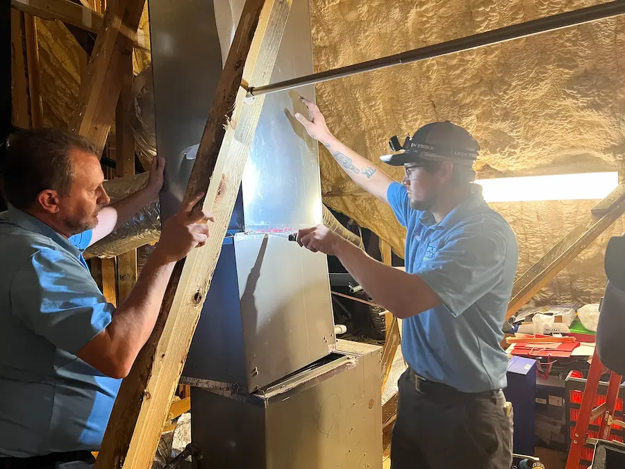 Workers inspecting furnace duct Heating Service Edmond