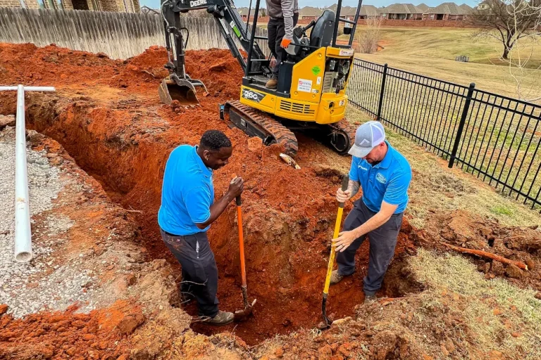Expert plumbing services in Edmond, OK - Triple Play Home services employees digging a trench for new plumbing lines.