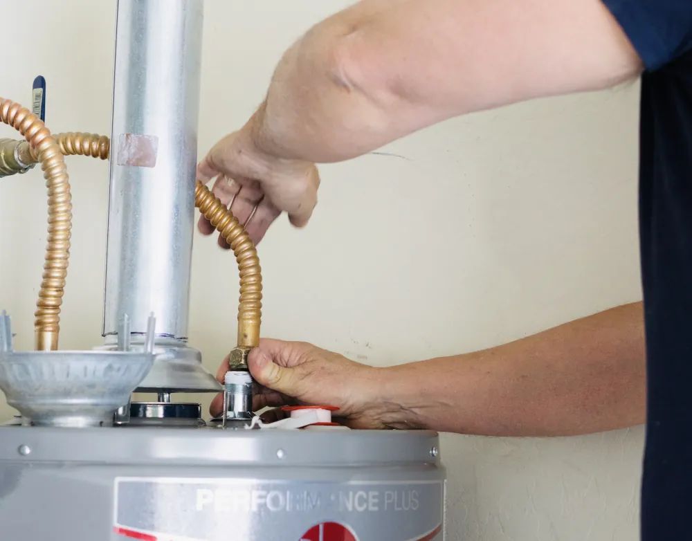 Water heater anode rods explained - Plumber making adjustments and tightening connections on new hot water heater