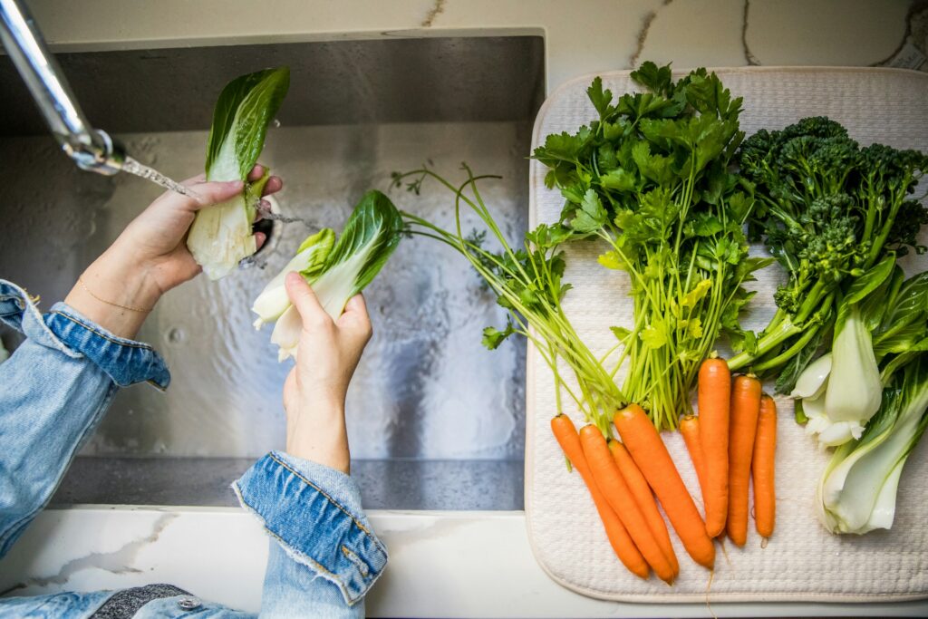 washing vegetables in the kitchen sink