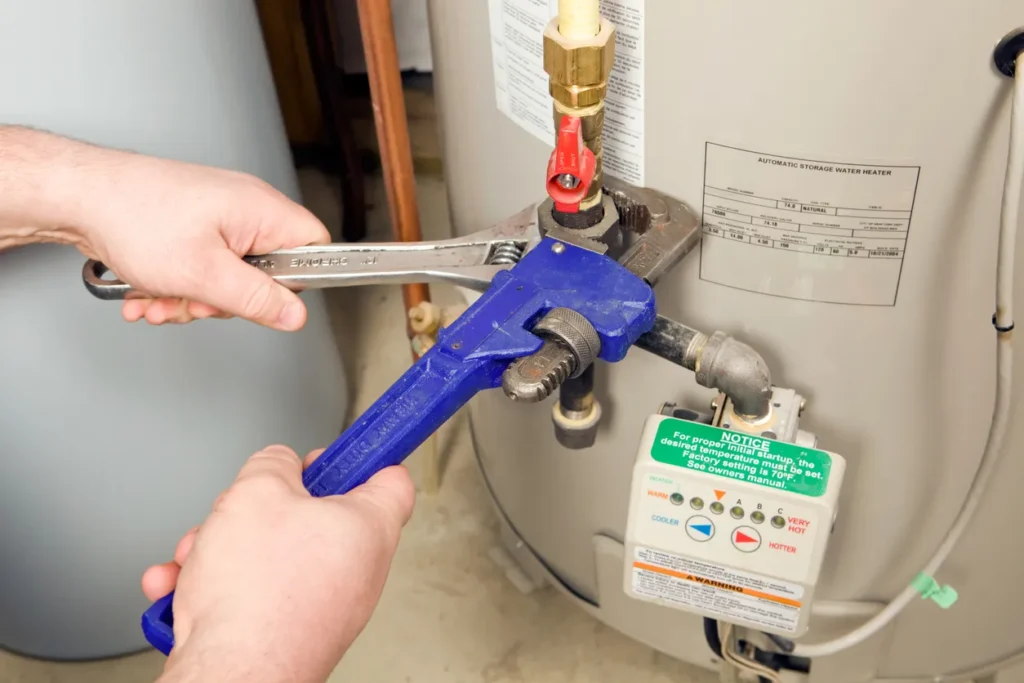 Plumber Pipe and Adjustable Wrenches on Gas Water Heater in Yukon, Ok.