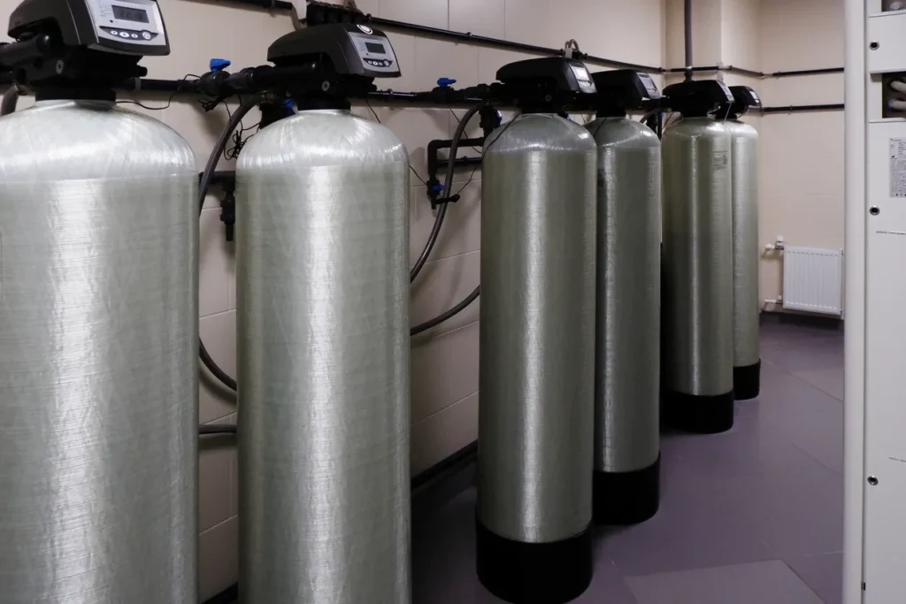 several water softener filters for water stand in a row water treatment system in Oklahoma City, OK.